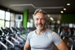 © ZaStock - Muscular mature older athlete looking at the camera in a gym near treadmill. healthy lifestyle