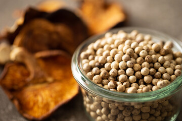 Canvas Print - White peppercorns and dried mushrooms