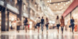 © Smile Studio AP - Blurred background of a modern shopping mall with some shoppers. Abstract motion blurred shopping.