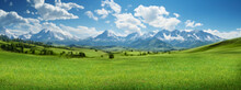 Landscape Featuring A Green Meadow And Snowy Mountains
