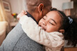 © C. Daniels/peopleimages.com - Father, child and hug in home living room for love, care and bonding together. Dad, girl and embrace in lounge for trust, support and quality family time to relax, smile and happy kid in house