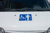 Fototapeta Miasto - Wheelchair and elder symbol on front of the car