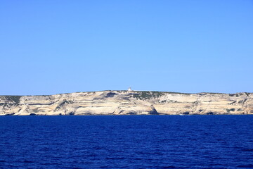 Wall Mural - Boat in front of Bonifacio beacon , Corsica, France