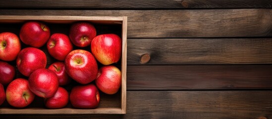 Poster - An aerial view of a wooden crate filled with newly harvested apples