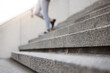Stairs, legs and city person leaving, walking or on urban journey, urban commute or trip to destination. Outdoor blur concrete cement steps and professional person departure on building staircase