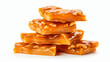 Stack of traditional peanut brittle candy pieces isolated on white background