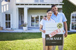 © Azeemud/peopleimages.com - New home, sold sign and happy couple portrait for house, real estate and property purchase, sale or investment. Mortgage, people hug and outdoor woman, man or homeowner embrace for relocation