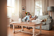© C. Daniels/peopleimages.com - Senior couple, sofa and relax with watching tv, phone and social media with hug, care and bonding in home. Mature man, woman and happy together on living room couch with movie, web chat and embrace