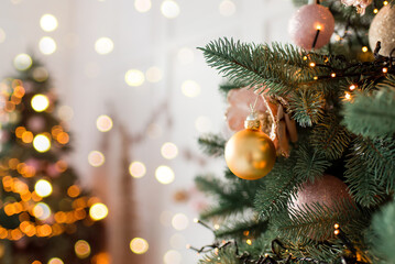 Wall Mural - christmas tree branches with decorations, balls, garlands, bokeh. postcard with space for text. merr