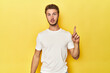© Asier - Young Caucasian man on a yellow studio background having some great idea, concept of creativity.