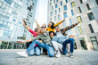 © Davide Angelini - Multi ethnic young people smiling together at camera outdoors - Happy group of friends having fun hanging out in downtown street - University students standing together in college campus