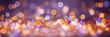 Christmas bokeh lights blurred background in gold and purple colors banner
