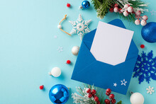 Top View Image Of A Santa's Wish List Letter With Festive Decorations, Pine Branches In Hoarfrost, And Holly Berries On A Pastel Blue Background With Blank Space For Text