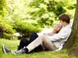 © Marius Venter/peopleimages.com - Park, relax and happy couple hug, love and cuddle in outdoor nature, green garden or grass field, pitch or lawn. Eye contact, wellness and romantic man, woman or marriage people embrace on ground