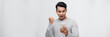 © makistock - Excited asian man isolated look at smartphone happy win lottery on mobile app online
