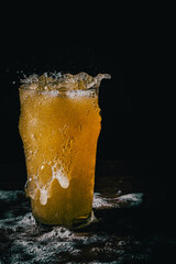 Wall Mural - Freeze motion of pouring beer into glass on black background