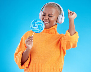 Poster - Music headphones, lollipop or black woman listening to radio playlist to relax on blue background in studio. Sweets, candy or girl singer dancing, singing or streaming a song audio or sound track