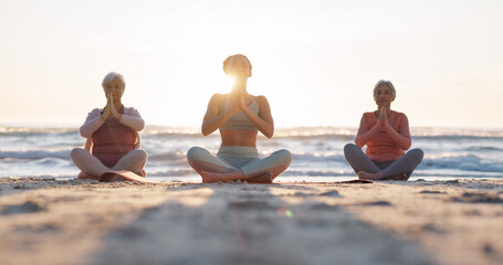 Beach yoga class, sunset and meditation instructor coaching zen mindset, spiritual chakra healing or breathing exercise. Freedom, calm and people learning pilates, training and coach teaching group