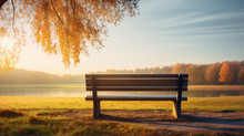 Wooden Bench On Park With Lake In Autumn
