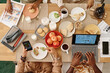 © AnnaStills - Family members busy with their own things when having breakfast at home together