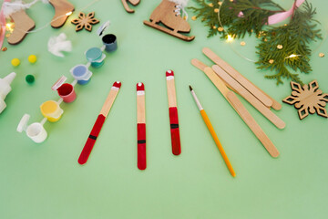 Wall Mural - Step by step instruction how to make christmas toy from ice cream sticks. Step 3 painting sticks red. Children's New year handmade craft