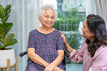 Wall Mural - Caregiver help Asian senior woman on wheelchair with love at home.