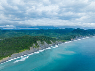 Wall Mural - Drone fly over the sea and shore with mountain