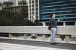 © aLListar/peopleimages.com - Business woman, rooftop and thinking with phone, vision and planning for future, career on ideas for goal. Entrepreneur, dream and brainstorming with smartphone for choice, decision or mindset in cbd