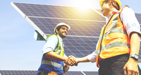 caucasian male architect and asian engineer electrician shaking hands working colleagues team believ