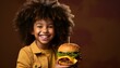 child holding a cheeseburger 