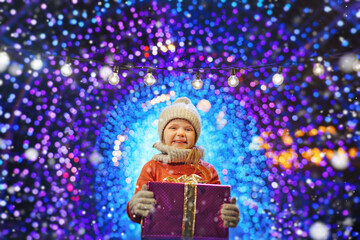 Wall Mural - little girl with Christmas gift enjoying the holidays