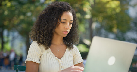 Poster - Young black woman working on laptop computer at a park