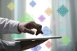 © New Africa - Marketing. Man using tablet computer indoors, closeup. Different icons near him