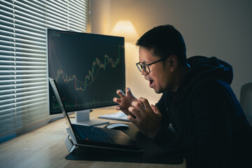 Wall Mural - Asian Businessman Depression serious checking Bitcoin or stock market price chart digital exchange on laptop monitor computer, cryptocurrency future price action prediction. Trading Stock Bitcoin ETF.