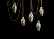 Christmas tree toys fir cones hanging on golden chains on dark background