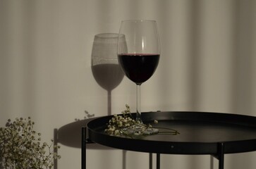 Glass of red wine on a small black table