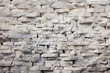 Textured white stone wall with varied block sizes
