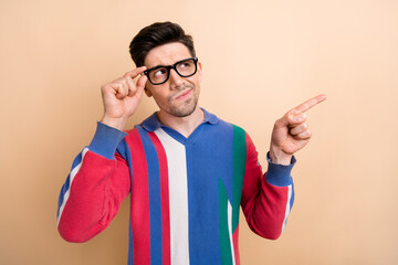 Sticker - Photo of young man thinking when directing his finger empty space information guess whats happened isolated on beige color background