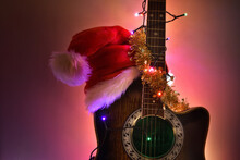 Guitar With Hat And Christmas Lights Isolated With Illuminated Background