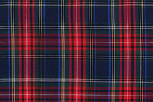 Close-up Of Red, Green And Blue Tartan Fabric Check Close-up. Background For Your Mockup. Traditional Scottish Clothing And Design.