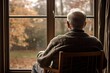 © Iryna - An elderly man sits alone by the window, showing signs of sadness, loneliness and health problems.