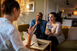 © Marko Geber - Therapist talking to a couple about their problems at home