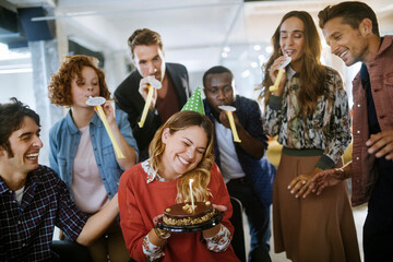 Wall Mural - Young businesspeople celebrating their colleagues birthday in office