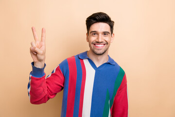 Sticker - Photo of satisfied glad young person beaming smile arm fingers demonstrate v-sign isolated on beige color background