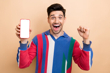 Poster - Photo of cool advertisement young guy celebrating mega sale black friday on phone display free coupon isolated on beige color background