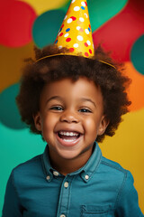 happy and smiling African American child boy celebrates his birthday, vivid and vibrant colors