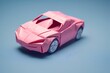 © Wirestock - Miniature pink model origami car displayed on a bright blue surface