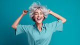 Fototapeta  - Portrait of attractive cheerful grey-haired woman dancing having fun rejoicing isolated over bright teal turquoise color background