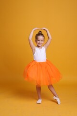 Sticker - Cute little girl in tutu skirt dancing on orange background