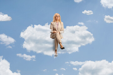 Sticker - Professional mature woman with glasses sitting on a cloud